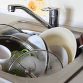 Dirty dishes and unwashed kitchen appliances filled the kitchen sink