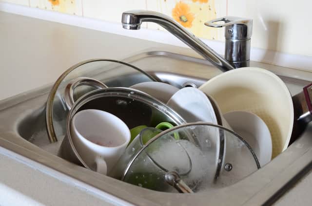 Dirty dishes and unwashed kitchen appliances filled the kitchen sink
