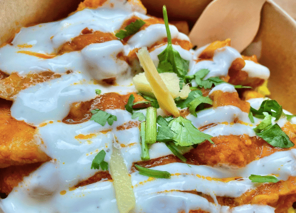 Home-style chicken curry with rice and your choice of yoghurt sauce and herbs from Indian Streatery in Birmingham City Centre