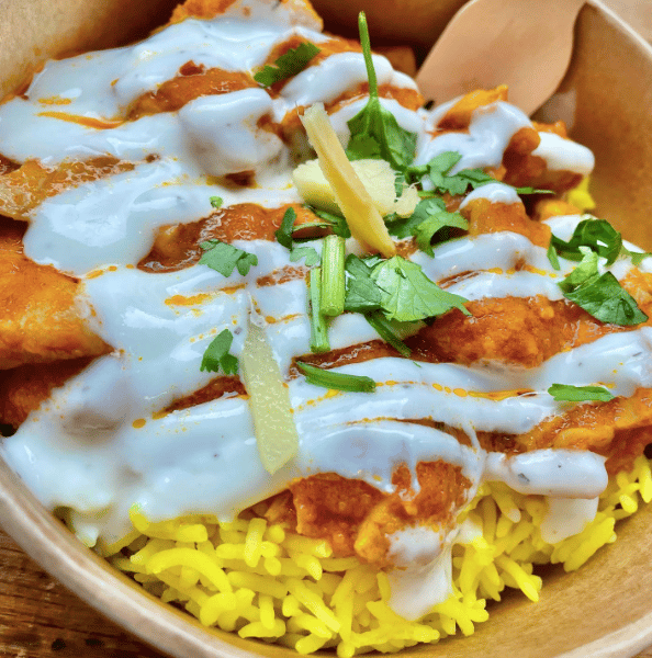 Home-style chicken curry with rice and your choice of yoghurt sauce and herbs from Indian Streatery in Birmingham City Centre