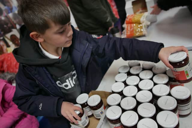 Food parcels for Ukraine being packed by refugees who want to help their friends back home 