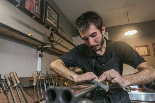 Andre Kesler, an employee at Horton’s & Sons, works on a damascus barrel from the late 1880’s at Hortons Gun Shop on Loveday Street, Birmingham