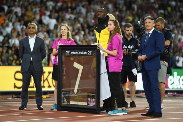 Usain Bolt of Jamaica is presented with a framed piece of the track from the London 2012 Olympics by IAAF President Sebastian Coe and Mayor of London Sadiq Khan (Photo by Matthias Hangst/Getty Images)