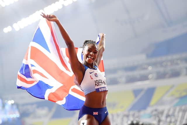 Dina Asher-Smith of Great Britain celebrates after winning gold in the Women’s 200 metres final during day six of 17th IAAF World Athletics Championships Doha 2019 at Khalifa International Stadium on October 02, 2019 in Doha, Qatar. (Photo by Matthias Hangst/Getty Images)
