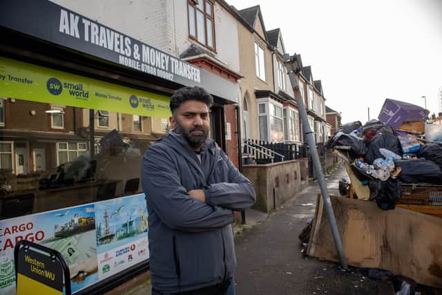 Abrar Khan owner of AK Travel & Money Transfer, outside his shop on Sladefield Road in Ward End, Birmingham