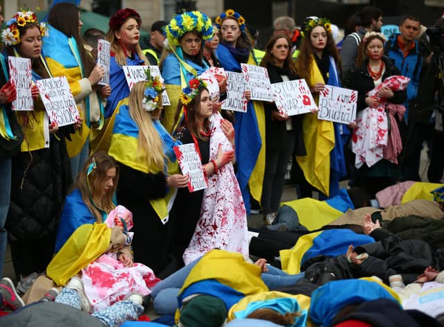 Protestors show their support for Ukraine in the UK. (Photo by Hollie Adams/Getty Images)