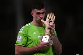 Martinez poses with the FIFA Golden Glove award during the trophy ceremony at the end of the Qatar 2022 World Cup final.
