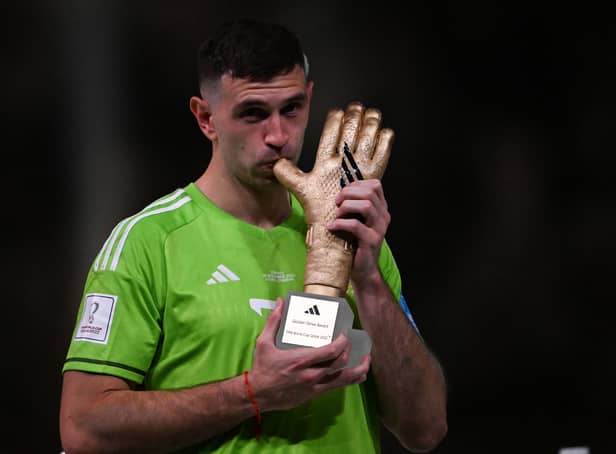 Martinez poses with the FIFA Golden Glove award during the trophy ceremony at the end of the Qatar 2022 World Cup final.