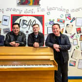 UB40 in front of pupil's work researching the band at St Edwards Catholic School in Birmingham 