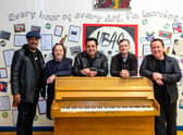 UB40 in front of pupil's work researching the band at St Edwards Catholic School in Birmingham 
