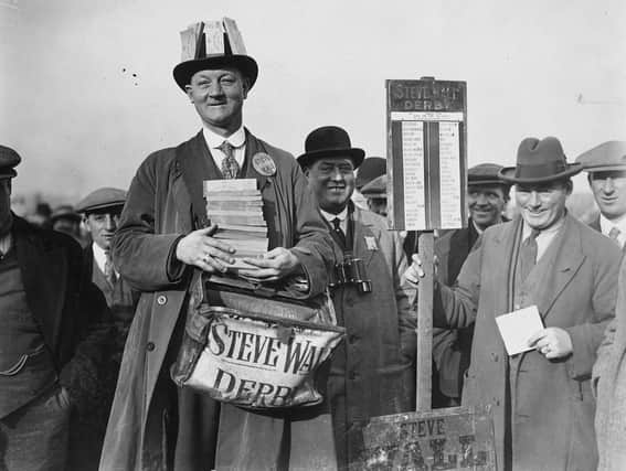 1st November 1926:  Punters queue up to lay their bets at Steve Wall’s bookmaking stand at Birmingham Race Course. The inauguration of a betting tax means that the bookmaker must be well supplied with revenue tickets.  (Photo by Kirby/Topical Press Agency/Getty Images)