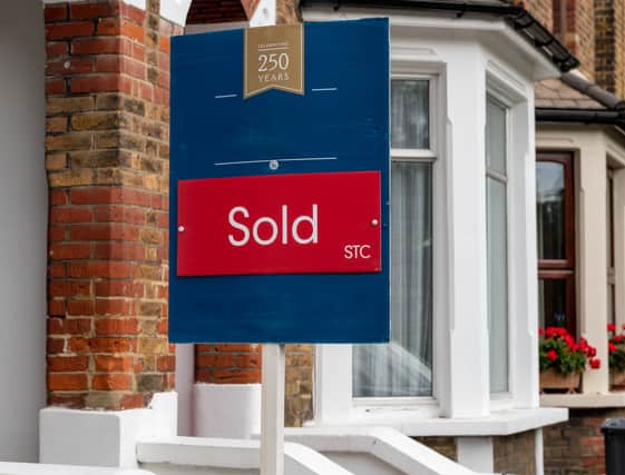 A property sold sign outside a suburban terrace house 