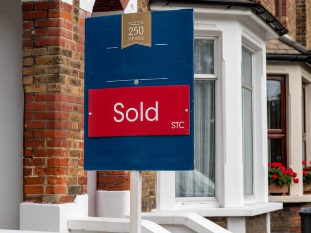 A property sold sign outside a suburban terrace house 