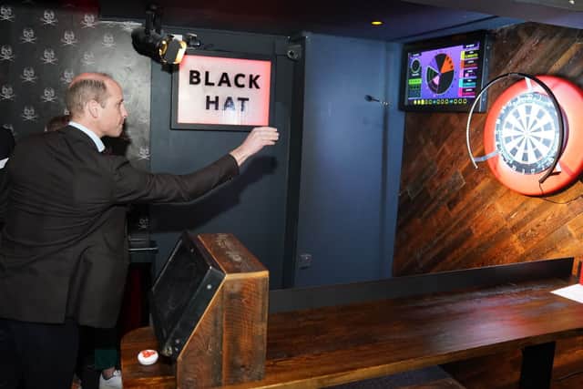 Prince William, Prince of Wales takes part in a game of interactive darts in the 180 Club during a visit to The Rectory during their visit to Birmingham on April 20, 2023 in Birmingham, England. (Photo by Jacob King - WPA Pool/Getty Images)