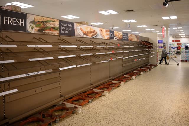 A shopper peruses near-empty bread shelves at a supermarket (Getty Images)