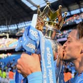 Jack Grealish poses with the Premier League trophy - (Photo: Getty)