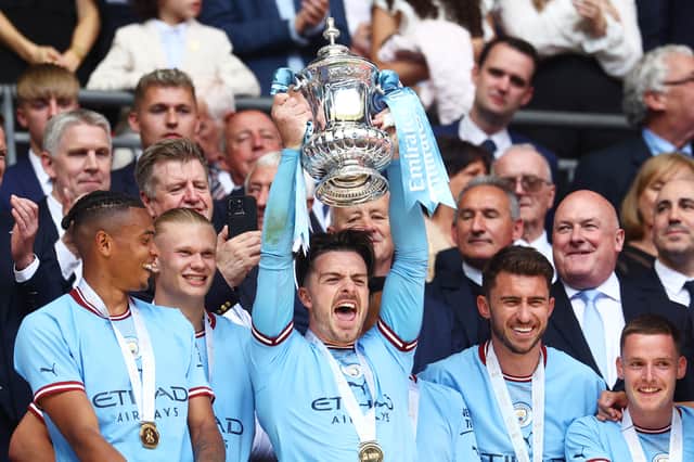 Jack Grealish lifts the FA Cup trophy. (Photo - Getty Images)