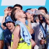 Kalvin Phillips pours Grey Goose into the mouth of Jack Grealish as they celebrate on stage in St Peter’s Square during the Manchester City Treble trophy parade 