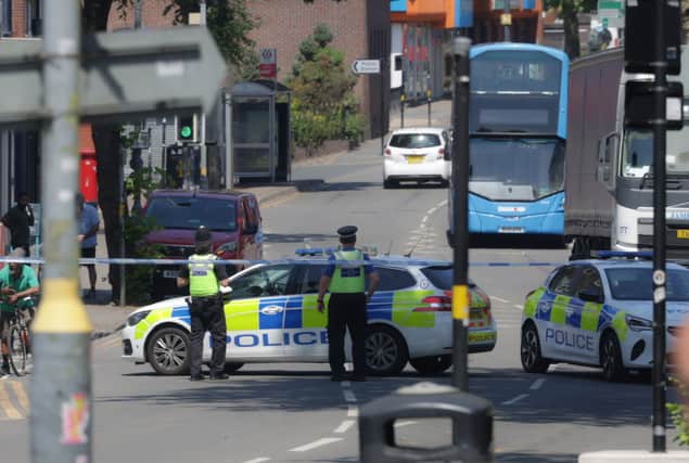 Police investigate a crash on Kings Heath High Street in Birmingham after a woman and boy were struck by a car