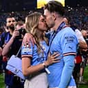 Manchester City's English midfielder #10 Jack Grealish (R) celebrates with his girlfriend Sasha Attwood (Photo by MARCO BERTORELLO/AFP via Getty Images)