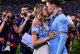 Manchester City's English midfielder #10 Jack Grealish (R) celebrates with his girlfriend Sasha Attwood (Photo by MARCO BERTORELLO/AFP via Getty Images)