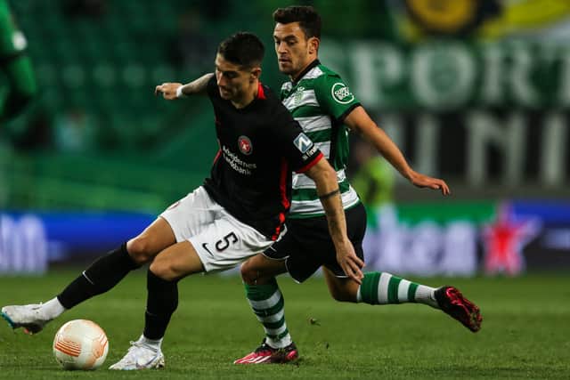 Martinez wins back possession from Sporting Lisbon midfielder Pedro Goncalves during the Europa League round of 32 clash in Lisbon.