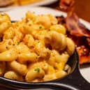 CREAMY HOMEMADE MACARONI COVERED WITH A CRISPY CHEESE CRUST AND SPRINKLED WITH JERK SPICES FOR A PERFECT RICH TASTE.
