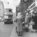 February 1962:  Women waiting in a bus queue outside a shop in Corporation Street, Birmingham.  (Photo by Marshall/Fox Photos/Getty Images)