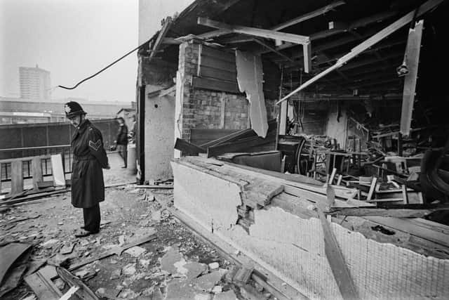 A police officer stands before the damage caused by one of the two pub bombings which hit the city on 21st November 1974, in Birmingham, West Midlands, England, 23rd November 1974. The bombings, which were attributed to the Provisional IRA, took place in two central Birmingham pubs, killing 21 and injuring 182 people. (Photo by Daily Express/Hulton Archive/Getty Images)