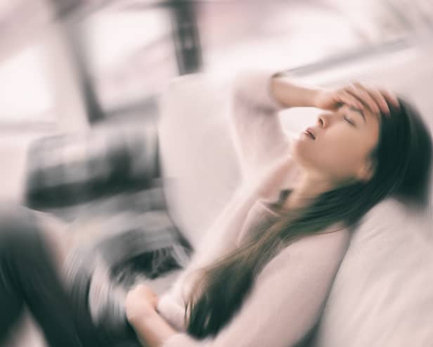 Stock image of woman holding her head in pain