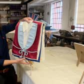 Sarah Hayes, Museum Director at the Coffin Works, shows us the Aston Villa shroud produced there