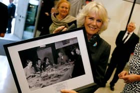 Queen Camilla poses with a picture of the original “Archers” radio soap cast(Photo by Luke MacGregor - WPA Pool/Getty Images)