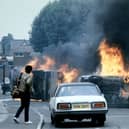 Burning cars are seen following riots in Handsworth, Birmingham on September 11, 1985. (Photo by Joel ROBINE / AFP) (Photo by JOEL ROBINE/AFP via Getty Images)
