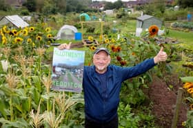Kevin Beresford holding his allotments calendar at Astwood Bank Allotments, Redditch, Worcestershire