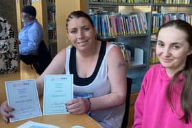 Hannah Joyce with her reading coach, Chelsey, after receiving certificates for completing the first two Read Easy modules
