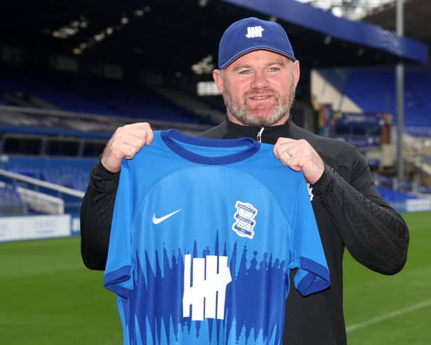 Wayne Rooney, Manager of Birmingham City holds up a Birmingham City home shirt (Photo by Nathan Stirk/Getty Images)