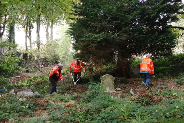 Volunteers clear and unkept plot of Brandwood End Cemetery