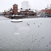 A member of the public makes their way across a snow covered Brindley Palce Canal Basin on January 13, 2010 in Birmingham