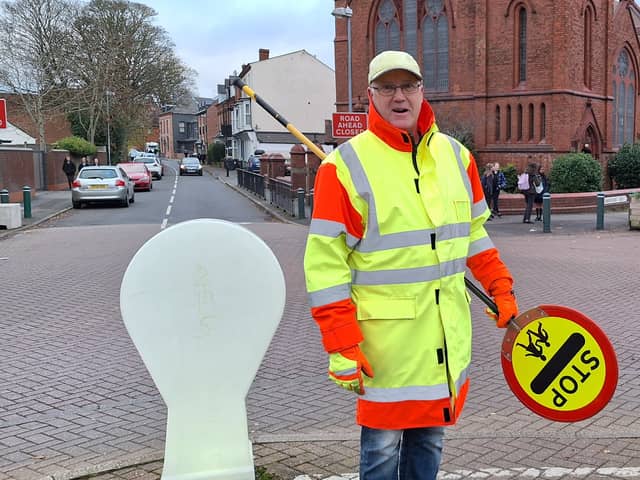 Kings Heath lollipop man Mark Swain is kept busy by the number of cars and the hundreds of children walking to school. Credit: LDRS