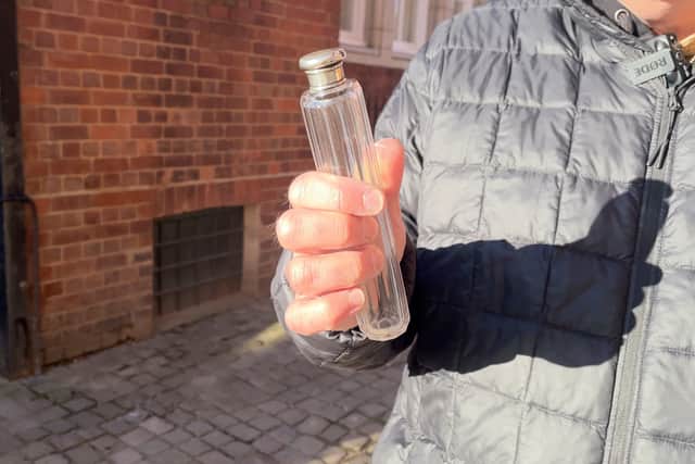 Kevin Thomas shows the glass bottle made at the factory in the Jewellery Quarter