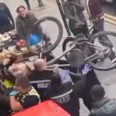 Officers attempt to push back the man charging them with  BICYCLE in Villa Road, Lozells, Birmingham