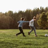 Teenagers playing football
