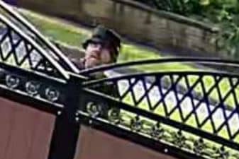 One of the two men that police are hunting in connection with an arson at a property on Scott Hall Road, Leeds