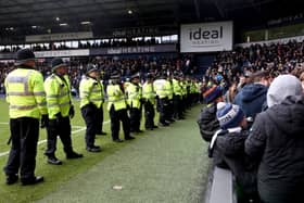 WEST BROMWICH, ENGLAND - JANUARY 28: Local police officers stand to prevent a pitch invasion during the Emirates FA Cup Fourth Round match between West Bromwich Albion and Wolverhampton Wanderers at The Hawthorns on January 28, 2024 in West Bromwich, England. (Photo by Catherine Ivill/Getty Images)