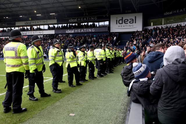 WEST BROMWICH, ENGLAND - JANUARY 28: Local police officers stand to prevent a pitch invasion during the Emirates FA Cup Fourth Round match between West Bromwich Albion and Wolverhampton Wanderers at The Hawthorns on January 28, 2024 in West Bromwich, England. (Photo by Catherine Ivill/Getty Images)