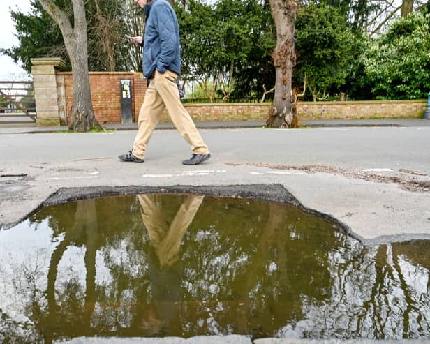 The huge pothole on Trinity Close in Stratford-upon-Avon, infront of the Holy Trinity Parish Centre and opposite to the Holy Trinity Church entrance