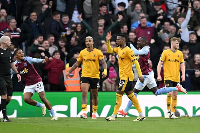 Mario Lemina, Nelson Semedo and Tommy Doyle of Wolverhampton Wanderers react after seeing Moussa Diaby open the scoring for Aston Villa against Wolves 