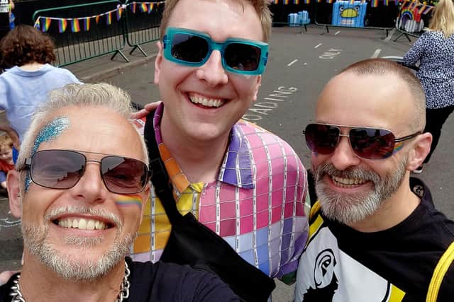 Richard and Justin at Queens Health Pride last year, with comedian Joe Lycett. 