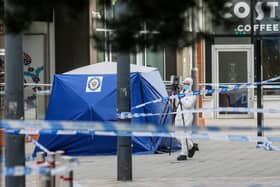 Police and forensic officers at New Square in West Bromwich