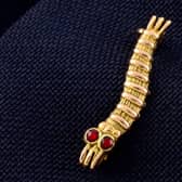 2cm gold Caterpillar Club pin, awarded to Sgt Bernard John Warren of the RAF 103 Squadron, has sold for more than £1K at auction